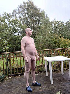 Nudist man standing outdoors, natural environment, nude, natural lifestyle.