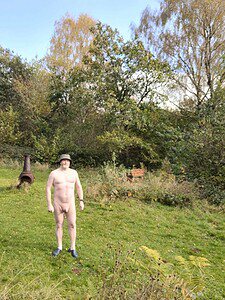 Naturist nudist nude naked penis in outdoor naturist environment.