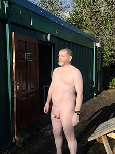 Naturist nudist nude naked penis man standing outside in natural light.