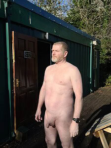 Naturist nudist nude naked penis man standing outside in natural light.