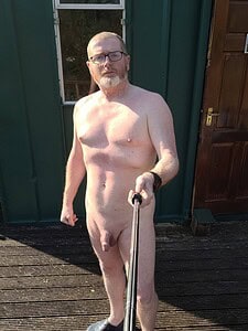 Naturist nudist nude naked penis, man taking selfie outdoors, full frontal view.