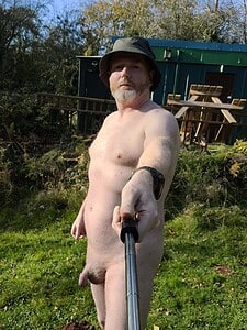 Naturist nudist nude naked penis in outdoor natural setting.