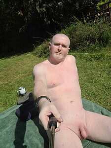 Naturist nudist nude naked penis in outdoor setting, man taking selfie.