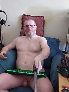 Naturist nudist nude naked penis, man sitting on sofa with selfie stick.